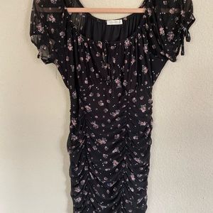 Black, floral, ruched dress with ties on sleeves and on bust.
